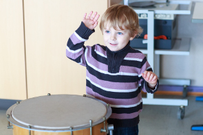 A Child playing on a drum